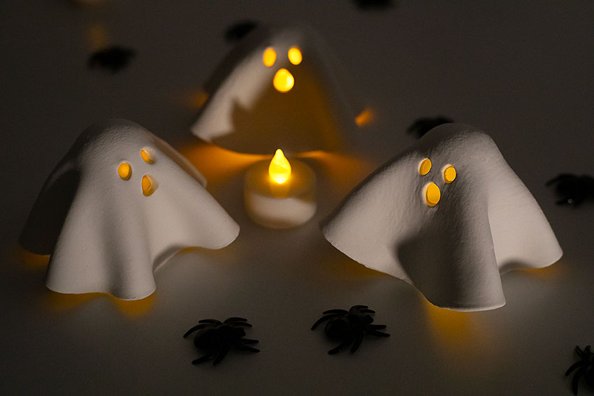 Ghost tea light holders with candles lit