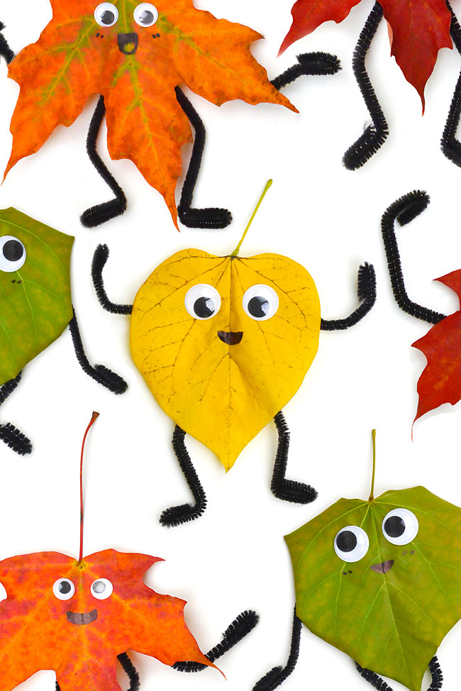 Collection of leaf people made with different colours of autumn leaves
