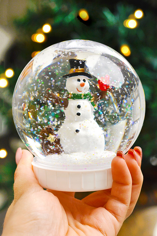DIY snow globe with a snowman figurine and glitter snow