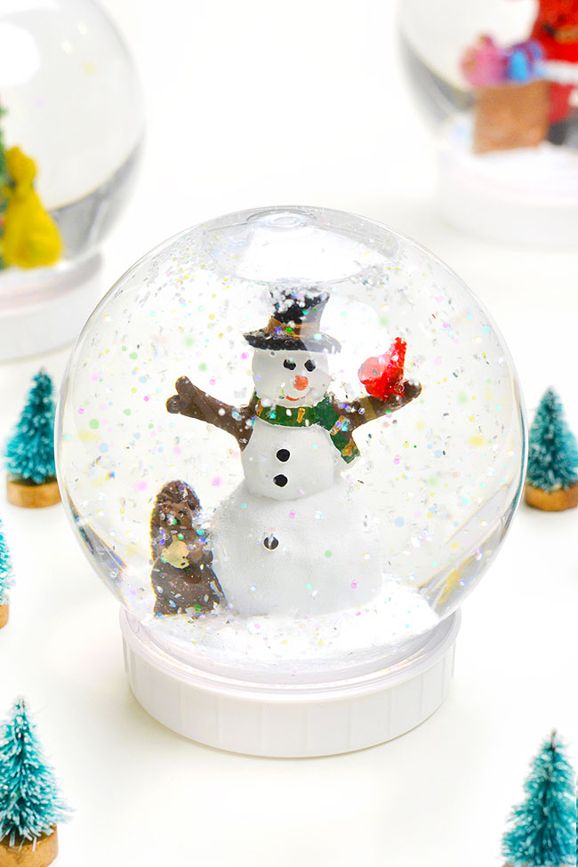 Cute DIY snow globe made with a shatterproof plastic globe