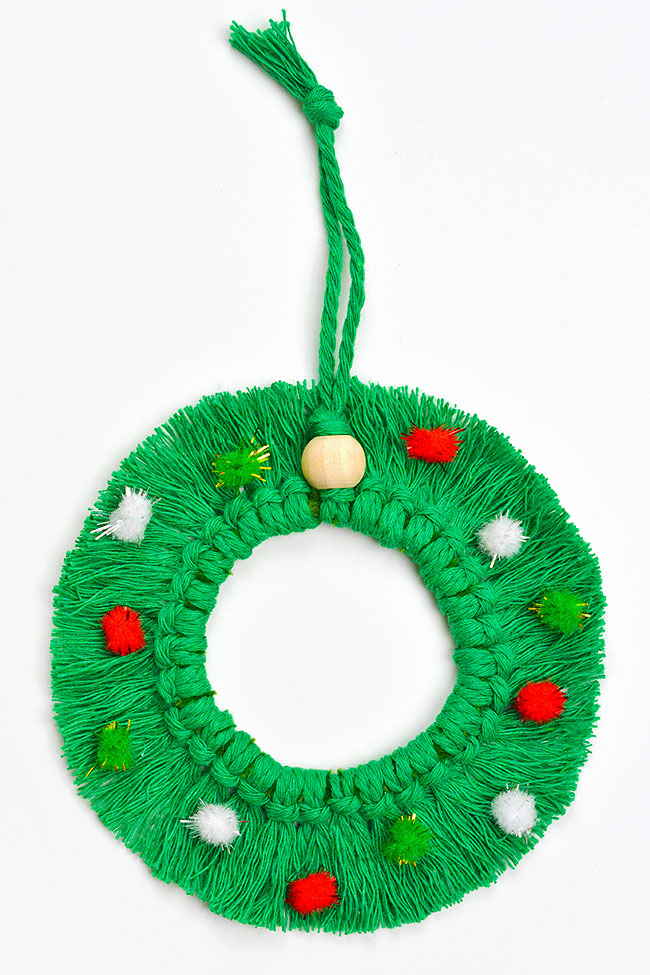 Macrame Christmas wreath ornament on a white background