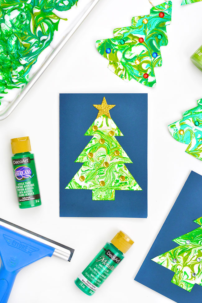 Paper Christmas trees marbled using shaving cream and acrylic paint