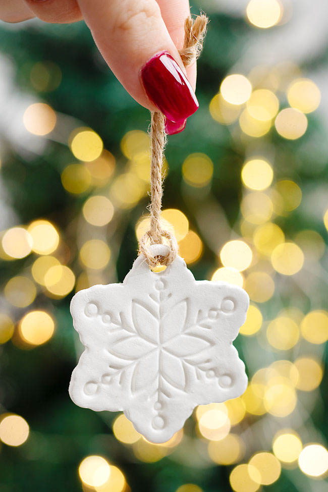 Snowflake shaped clay ornament in front of the Christmas tree