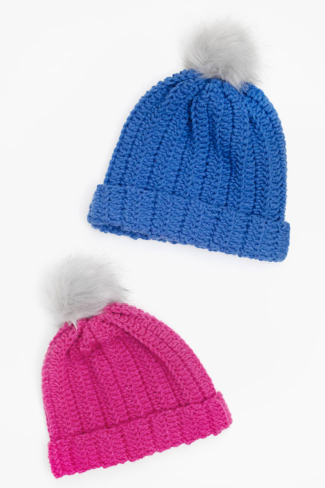 Blue and pink crochet beanies made with a beginner friendly pattern