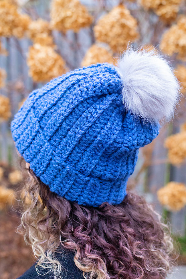 Wearing a blue crochet winter hat