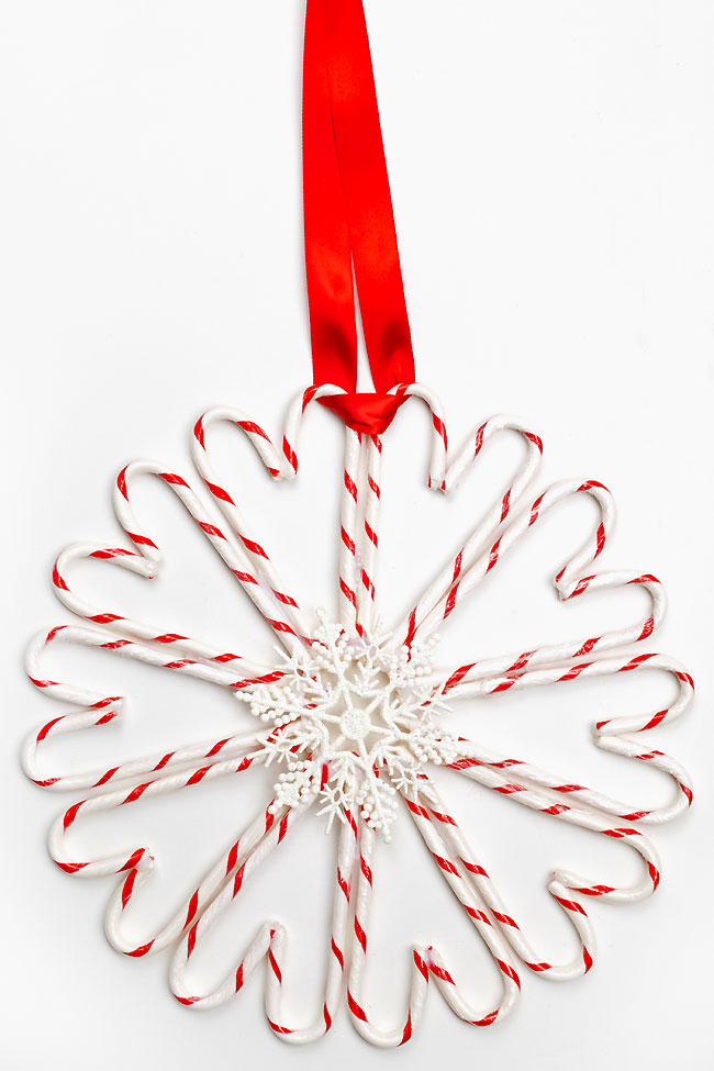 Red and white candy cane wreath with a snowflake ornament in the center