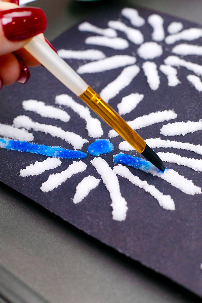 Painting with liquid watercolour paint on salt fireworks shapes