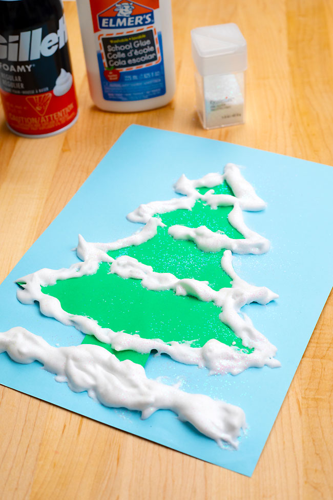 Decorating a Christmas tree template with snow paint