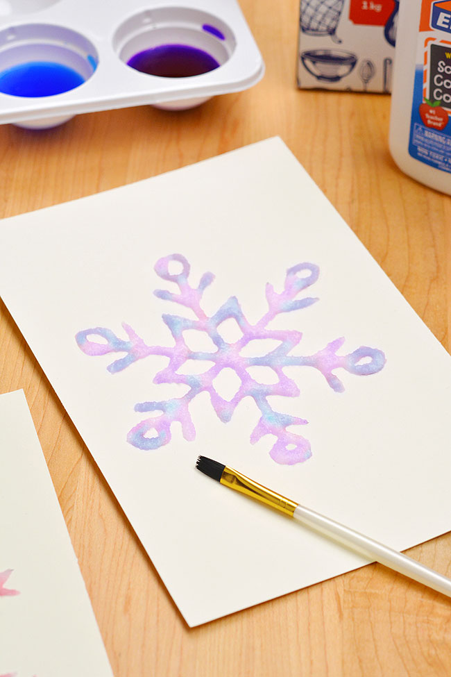 Pretty snowflake salt painting with liquid watercolor paint
