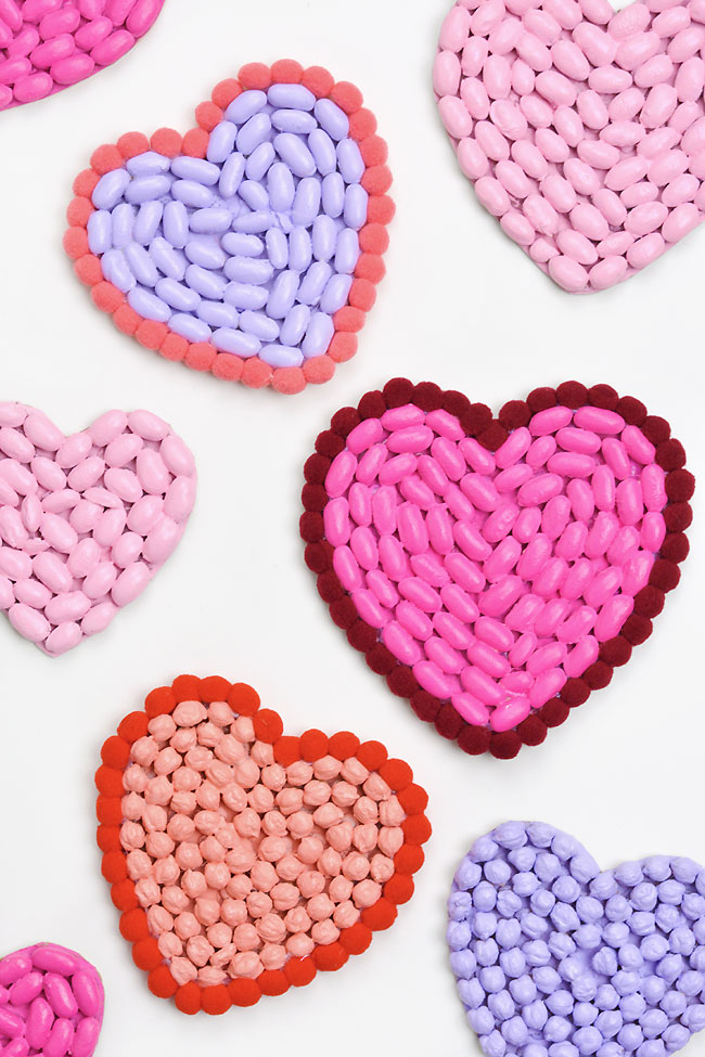 Cute bean art hearts for Valentine's Day, some with a pom pom border