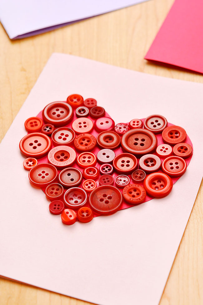 Red button art forming a heart on a DIY greeting card