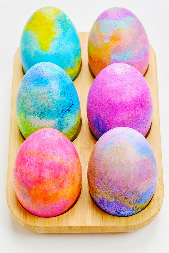 Pretty and colourful dyed Easter eggs in an egg tray