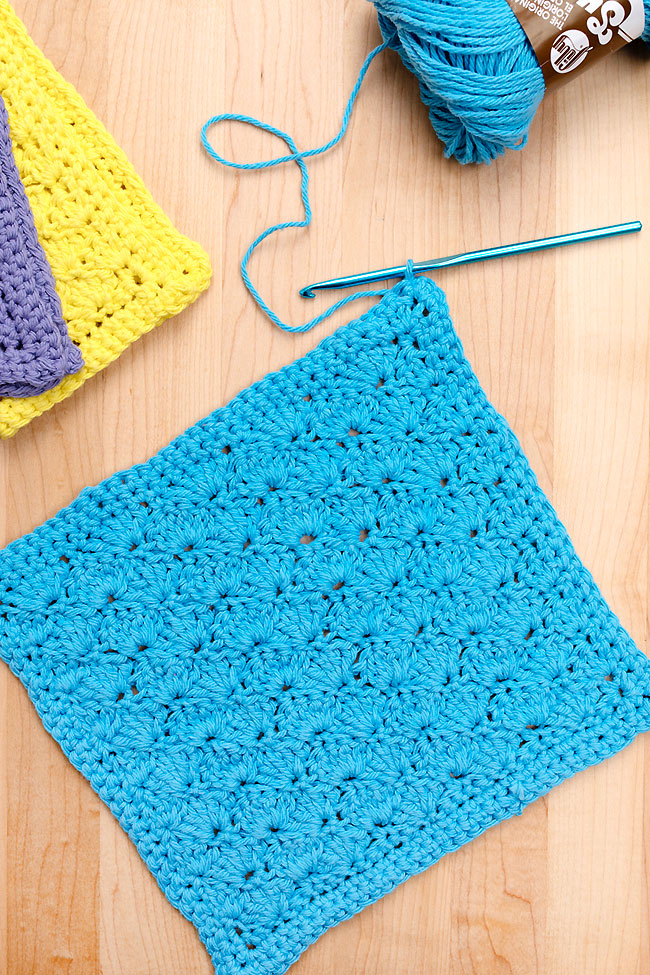Blue crochet dishcloth made with a free printable pattern