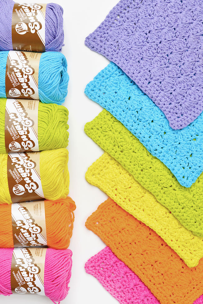 6 bright and cheerful colours of cotton yarn crocheted into washcloths