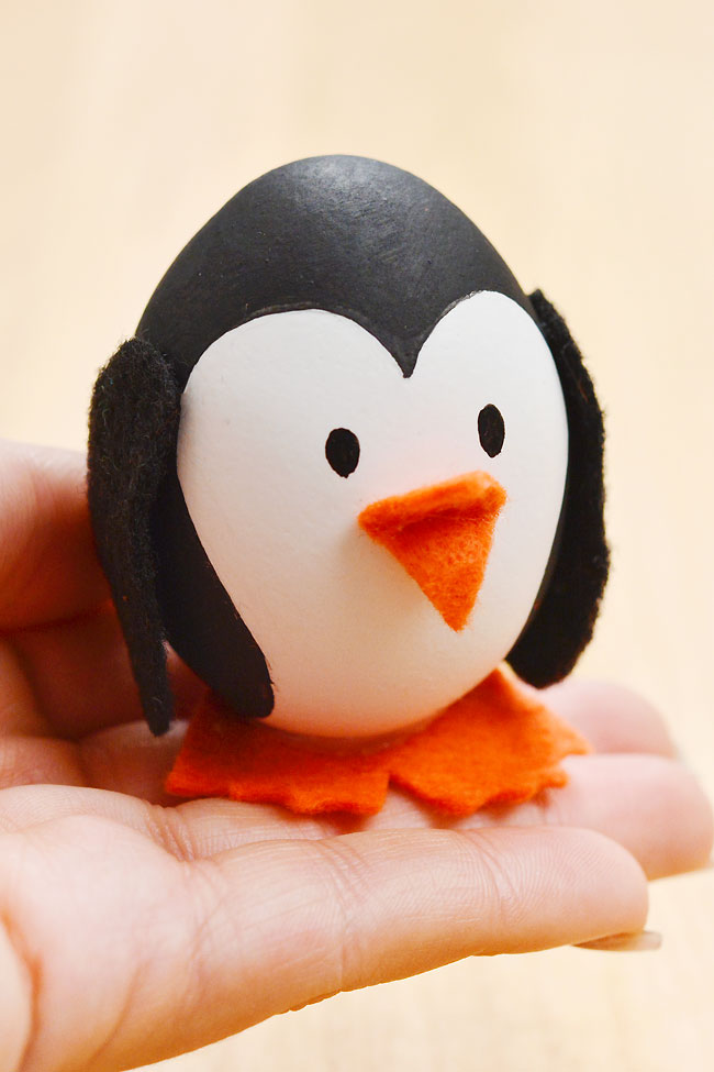 Closeup holding an Easter egg penguin