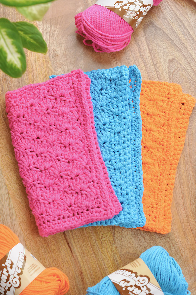 Pretty crochet dish rags on a wooden background