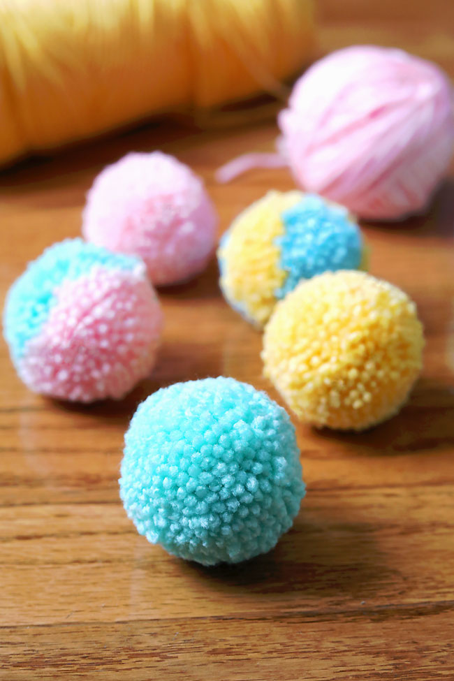 Cute yarn pom poms made with pastel coloured worsted weight yarn