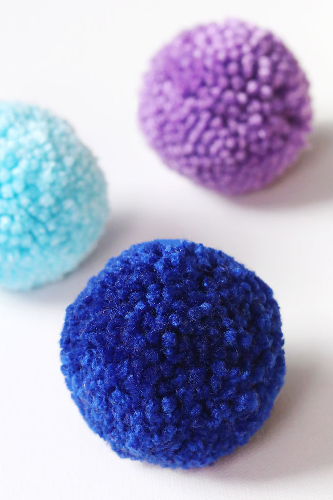 Closeup of colourful and fluffy homemade pompoms