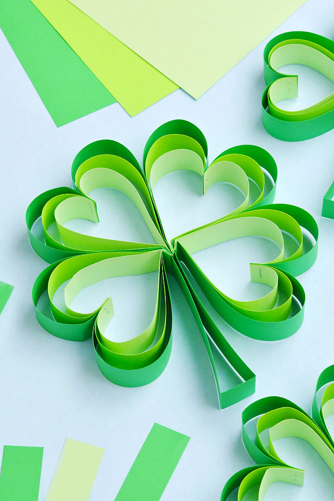 Homemade shamrock decorations made from stapled paper strips