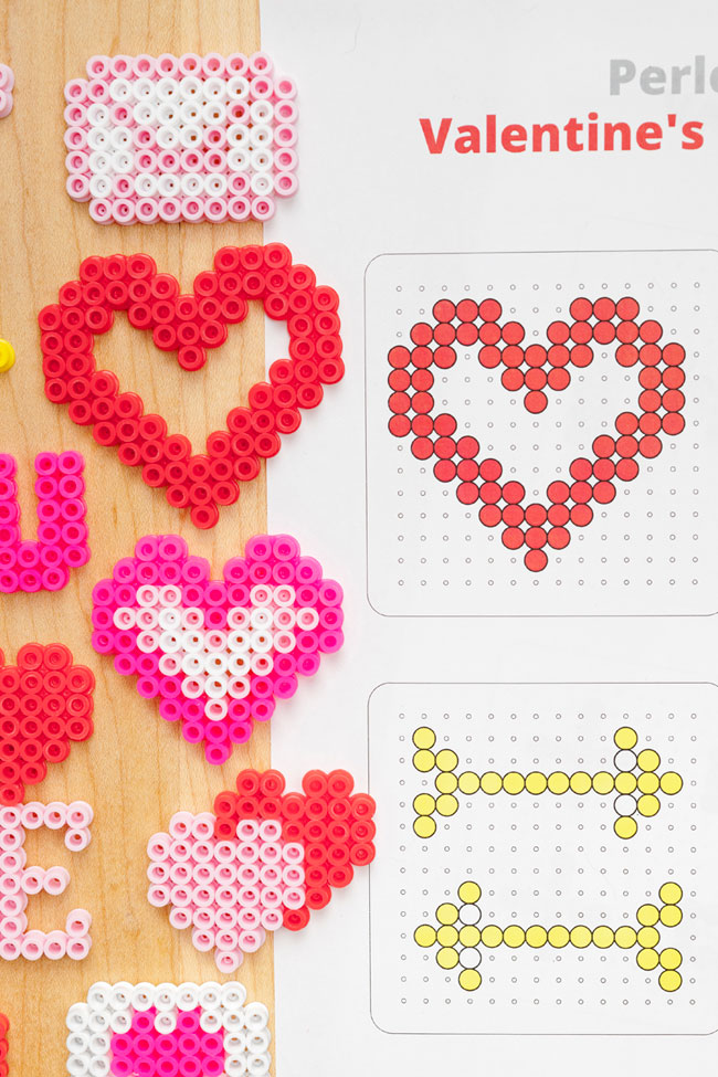 Valentine's Day Perler beads beside their printed patterns