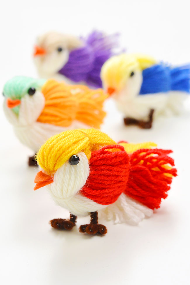 Group of DIY yarn birds on a white background