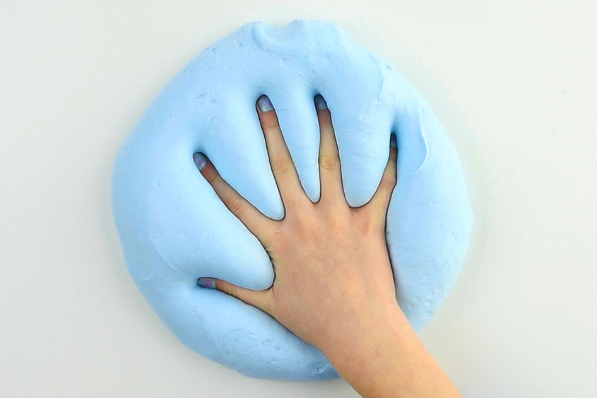 Pushing hand into fluffy slime