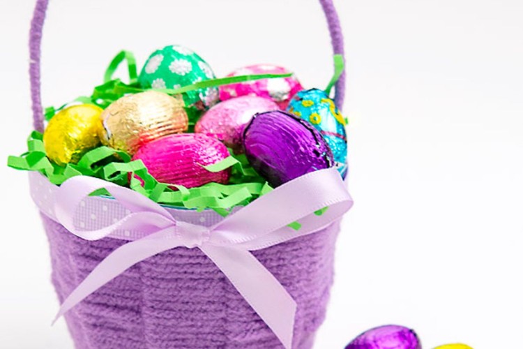 DIY Easter basket made with a paper cup, yarn, and ribbon