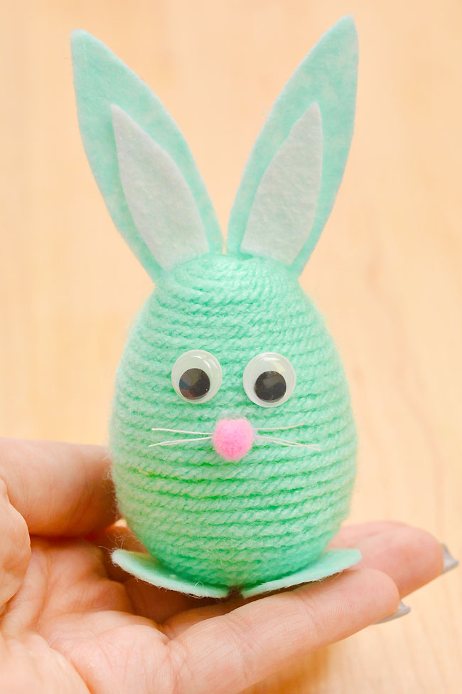 Holding a cute yarn wrapped bunny Easter egg