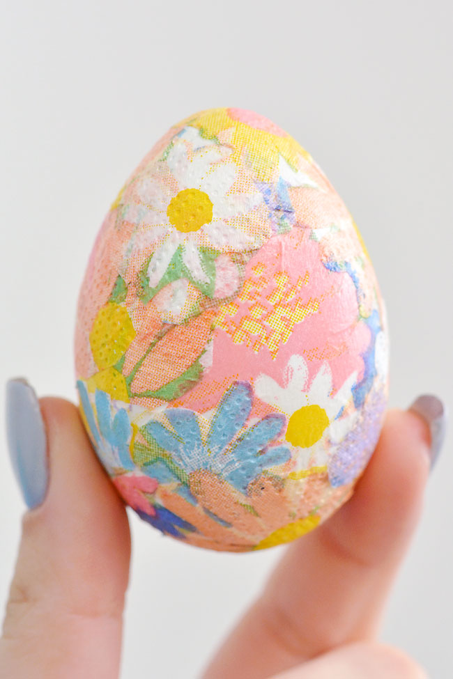 Holding a decoupage Easter egg made with paper napkins