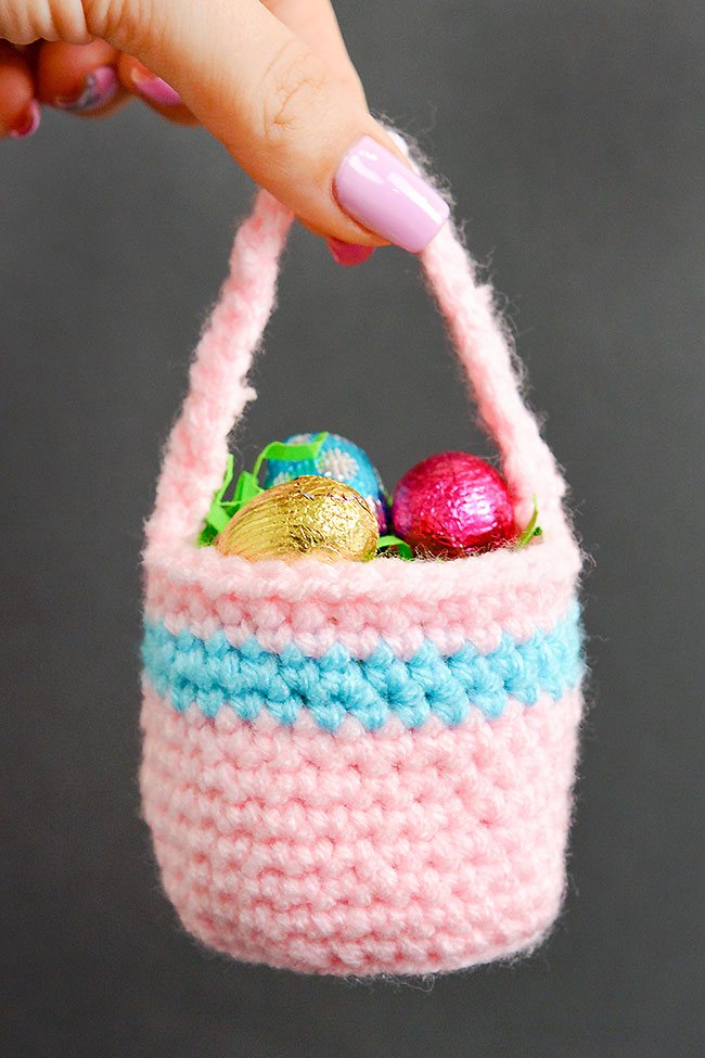 Holding a pink mini Easter crochet basket