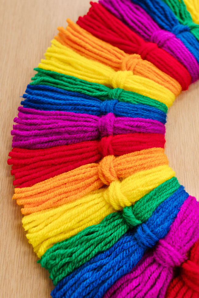 Closeup on the rainbow wreath tassels showing the yarn texture
