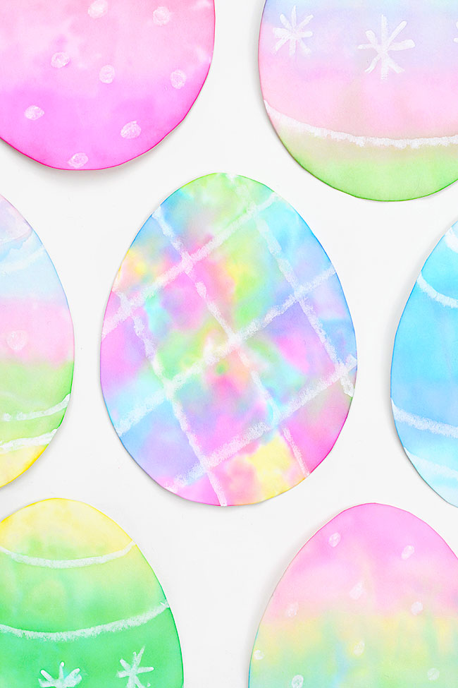 Group of tissue paper dyed Easter eggs on a white background