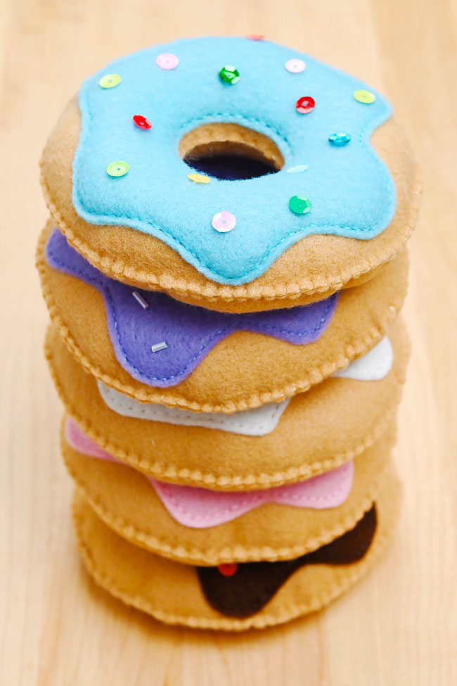 DIY felt donuts stacked together on a wooden background