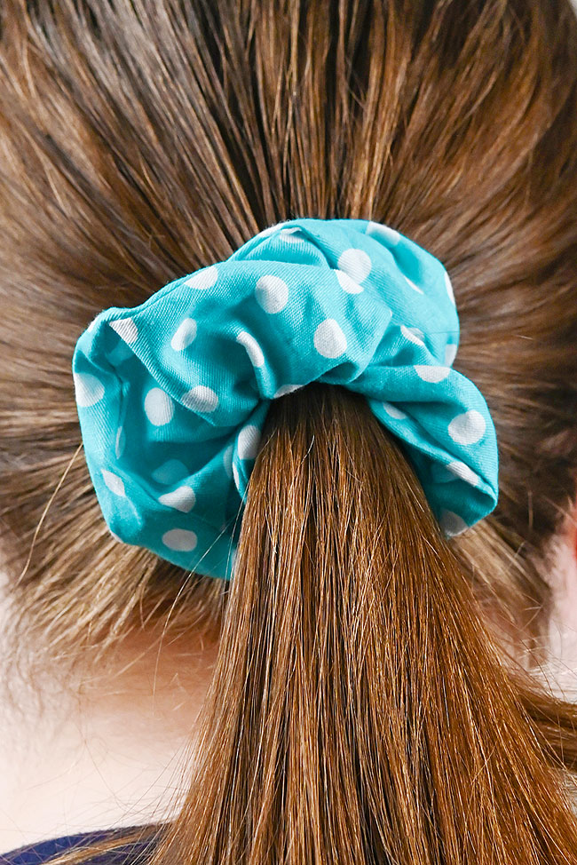 Wearing a blue polka dot hair scrunchie