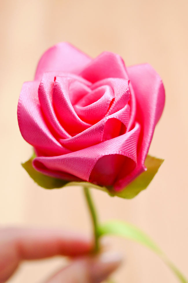 Closeup holding a DIY ribbon rose