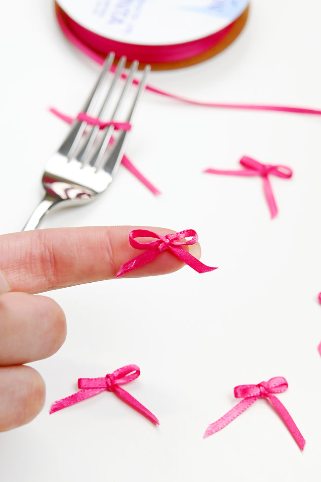 Mini bow tied with thin ribbon on a fork