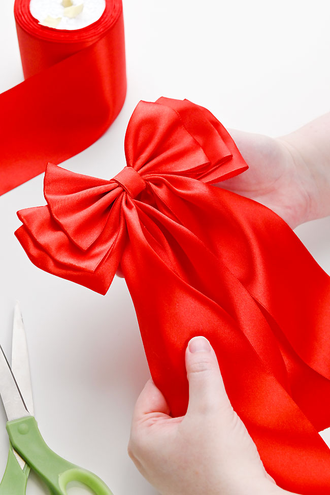 Large red triple layer bow that's perfect for Christmas and decorating wreaths