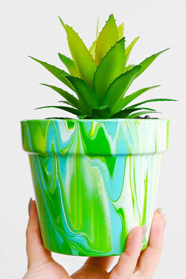 Terracotta flower pot decorated with paint pouring
