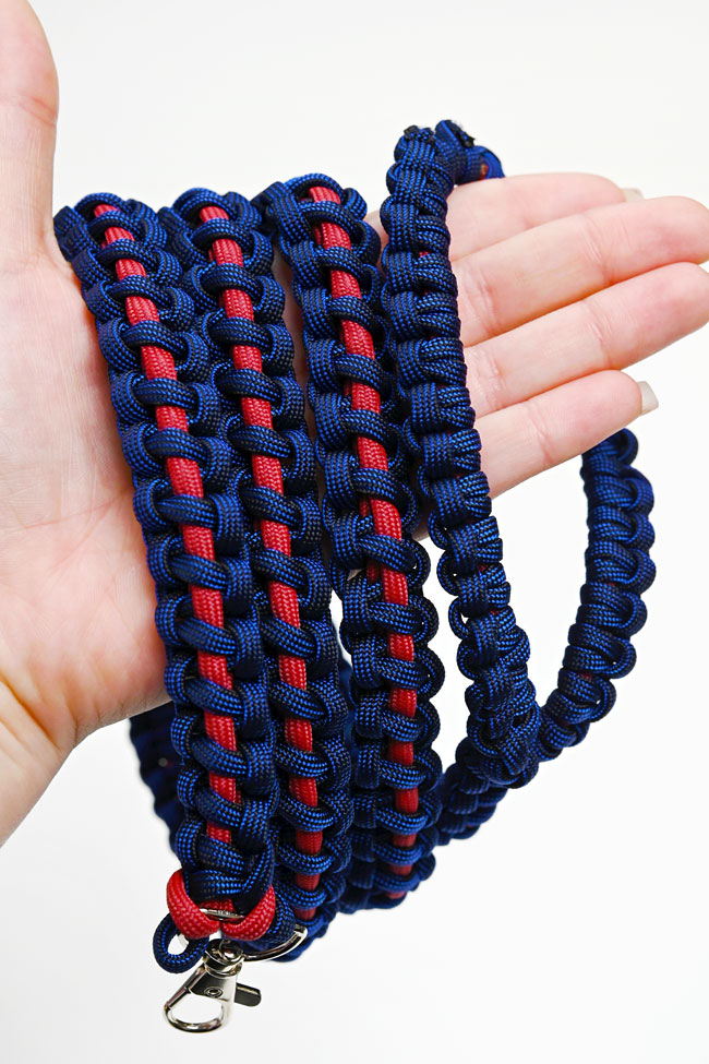 Holding a paracord dog leash made with a thin line solomon bar knot