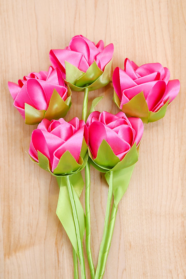 A group of ribbon roses on a wooden background