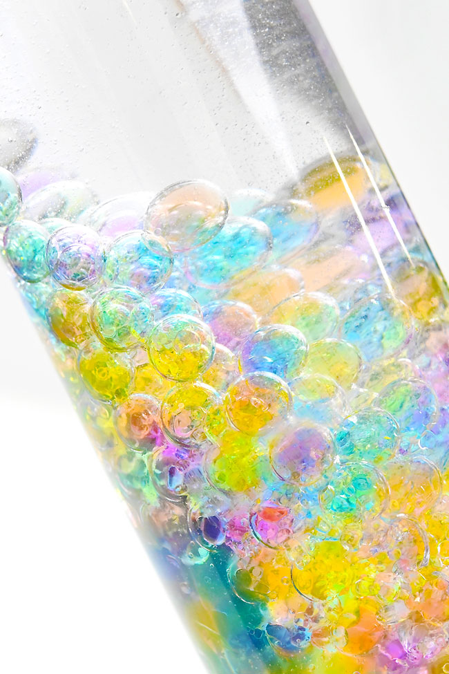Closeup on a water bead sensory bottle made with baby oil
