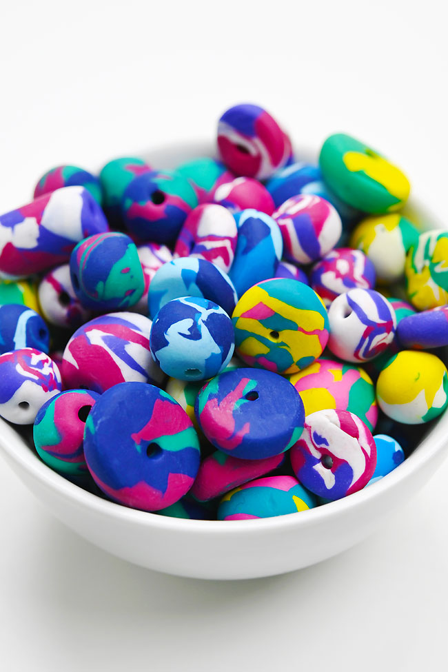 Bowl of homemade marbled polymer clay beads