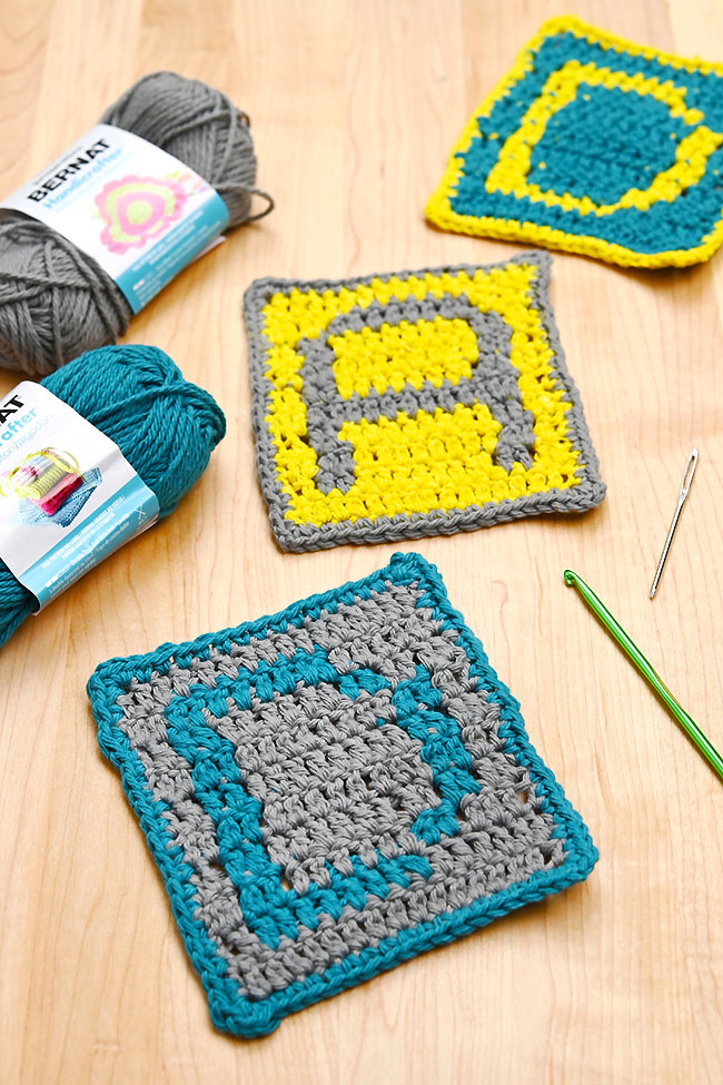 Crochet coasters spelling "DAD" made with cotton yarn