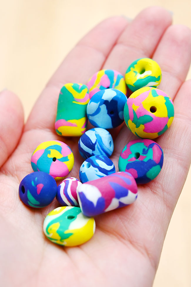 A handful of polymer clay beads in various shapes and sizes
