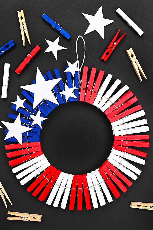 Clothespin wreath surrounded by clothespins and foam stars