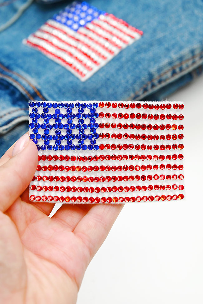 Holding a DIY rhinestone patch designed to look like the American flag