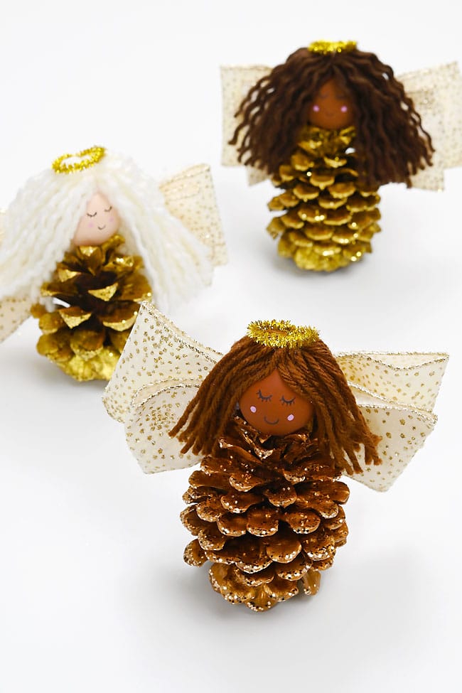 Angel Pine Cones Group of angel pine cone Christmas decorations on a white background