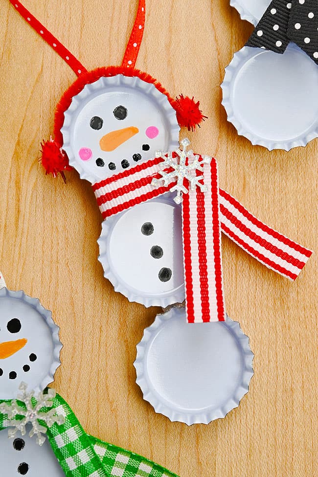 Bottle Cap Snowman Craft Closeup on a cute bottle cap snowman with a red striped scarf