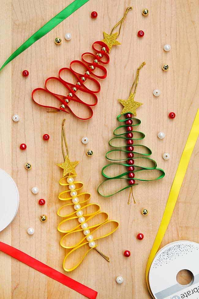 DIY Ribbon Christmas Tree DIY ribbon ornaments in the shape of Christmas trees with craft supplies to make them