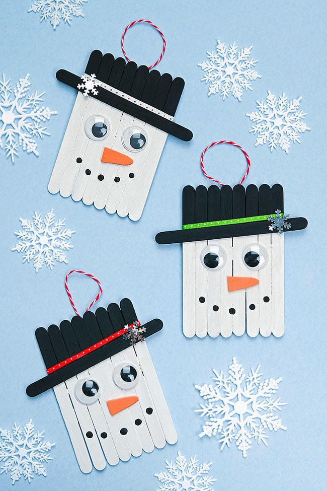 DIY Popsicle Stick Snowman Craft Cute snowman craft with snowflakes around them